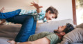 adult playing with child 767x418